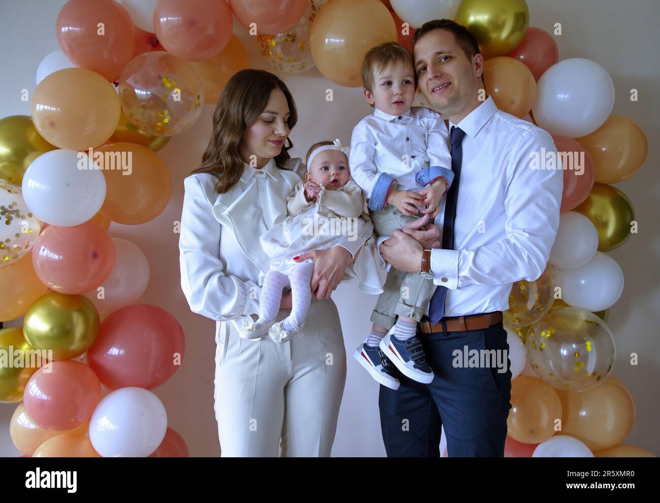 Young family celebrating christening of little baby girl Stock Photo