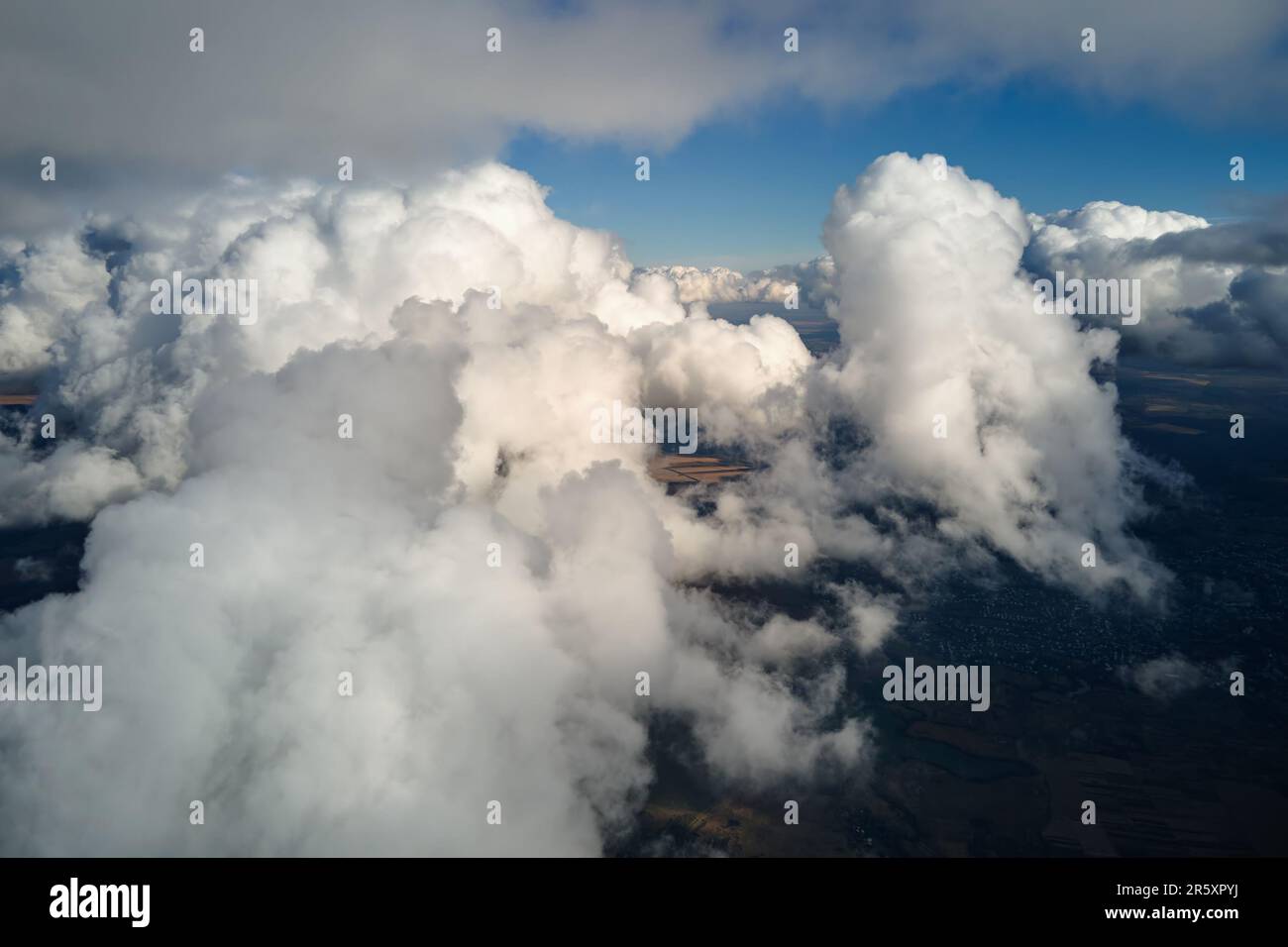 Aerial view at high altitude of earth covered with puffy cumulus clouds ...