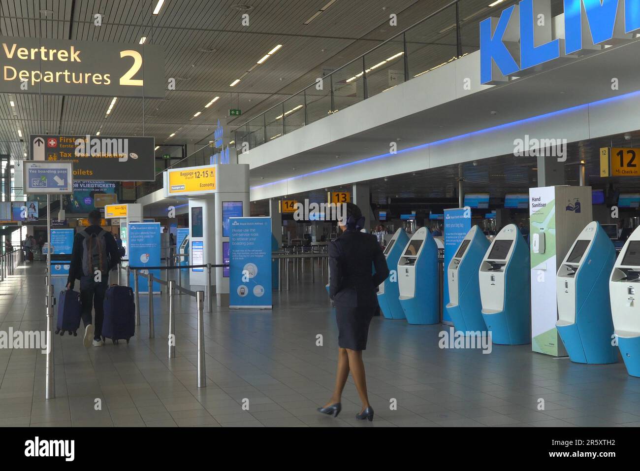 A passenger enters the automatic check in counters of KLM and Air