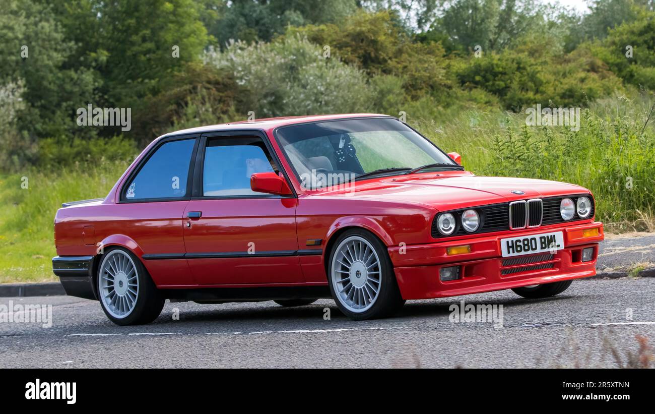 Stony Stratford,UK - June 4th 2023:  1991 BMW 3 SERIES 318i LUX classic car travelling on an English country road. Stock Photo