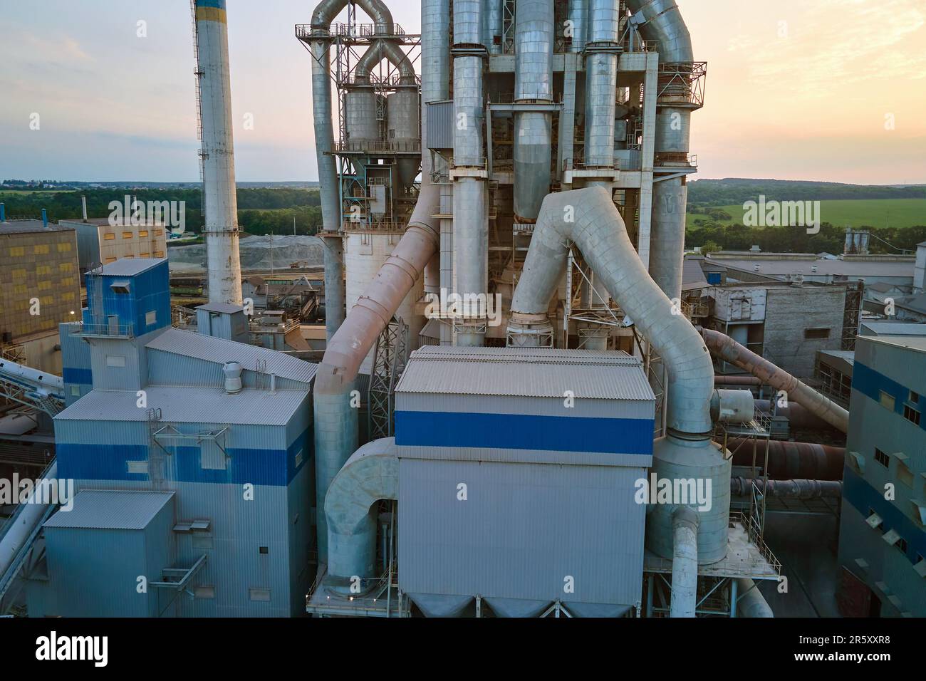 Cement plant with high factory structure and tower cranes at industrial