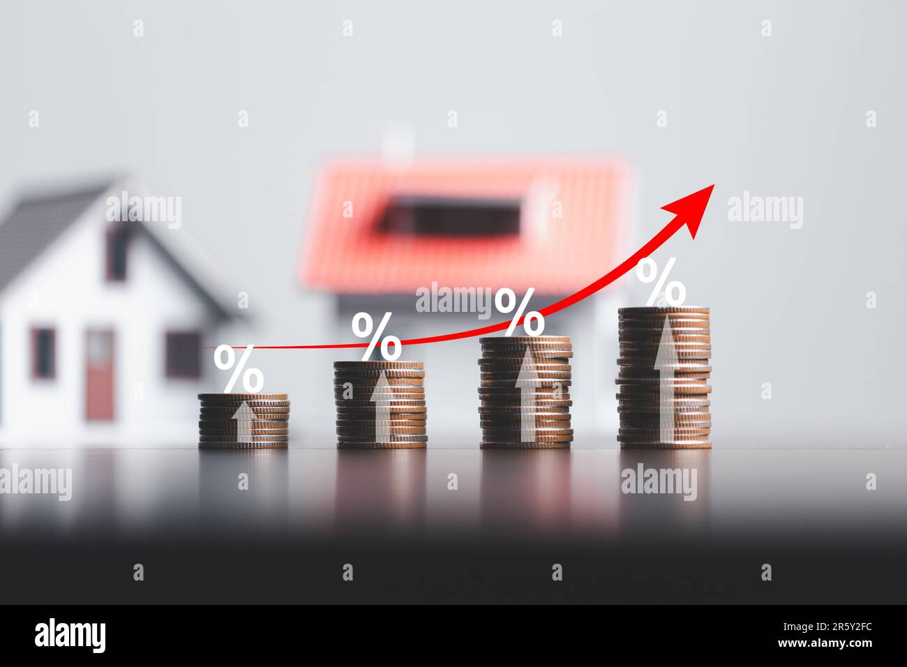 Stacks of coins and model house with percentage symbol for increasing ...