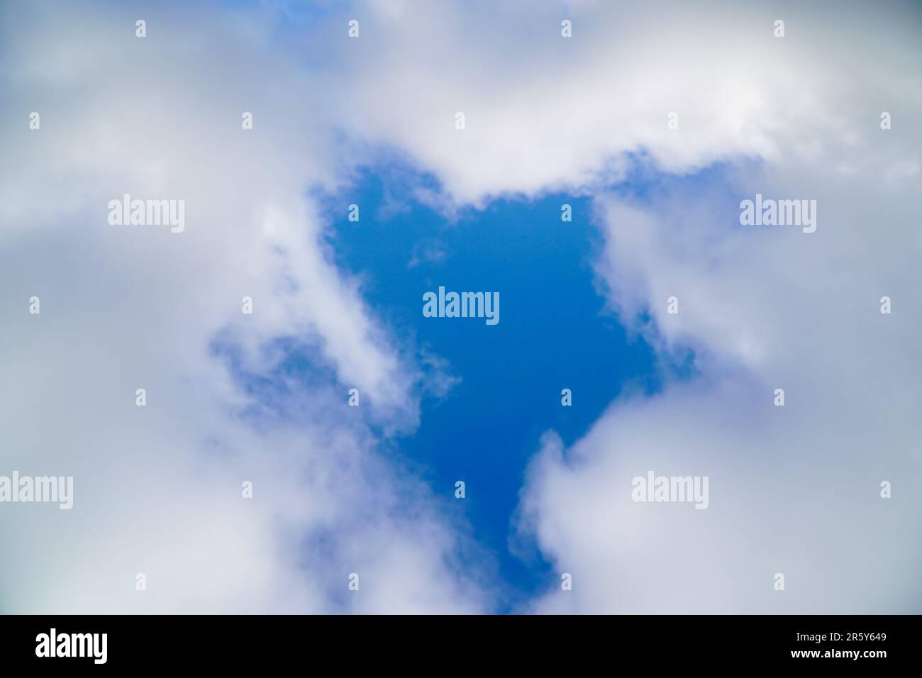 A hole in the white clouds, which is visible the blue sky. Soft focus Stock Photo