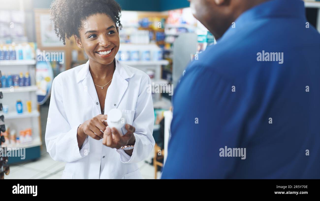 Try this, I promise youll feel a difference. a female pharmacist assisting a customer in a drugstore. Stock Photo