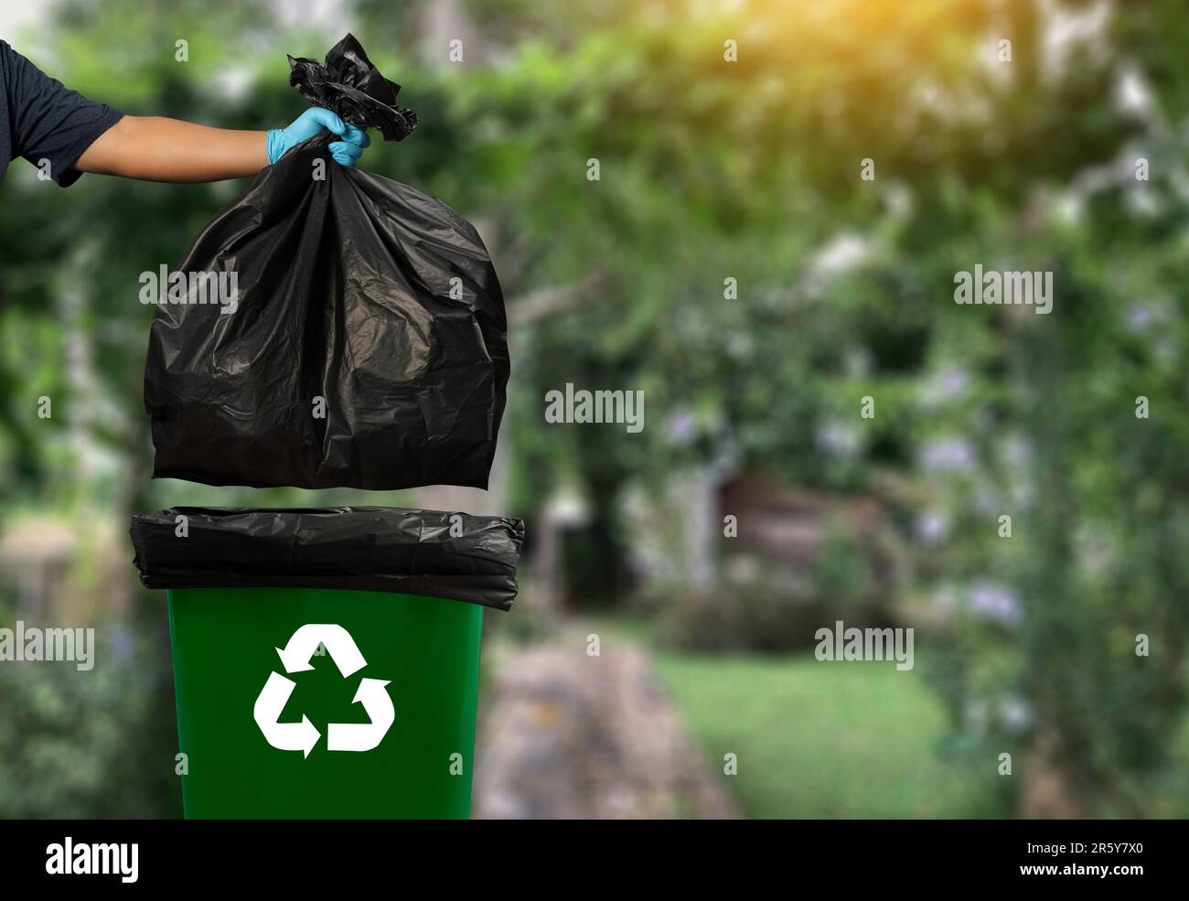 Man-hand garbage: putting plastic and glasses in reuse bin trash for ...