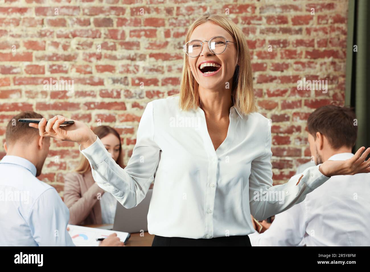 Businesswoman and her employees in office. Lady boss Stock Photo