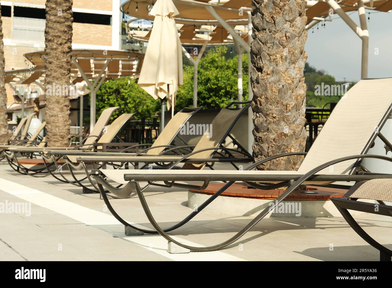 Sunbeds near swimming pool at luxury resort Stock Photo Alamy