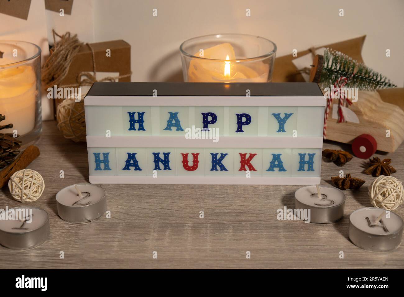 Candles with advent calendar Lightbox with text HAPPY HANUKKAH Traditional  Burning Christmas Wax Candles with numbers