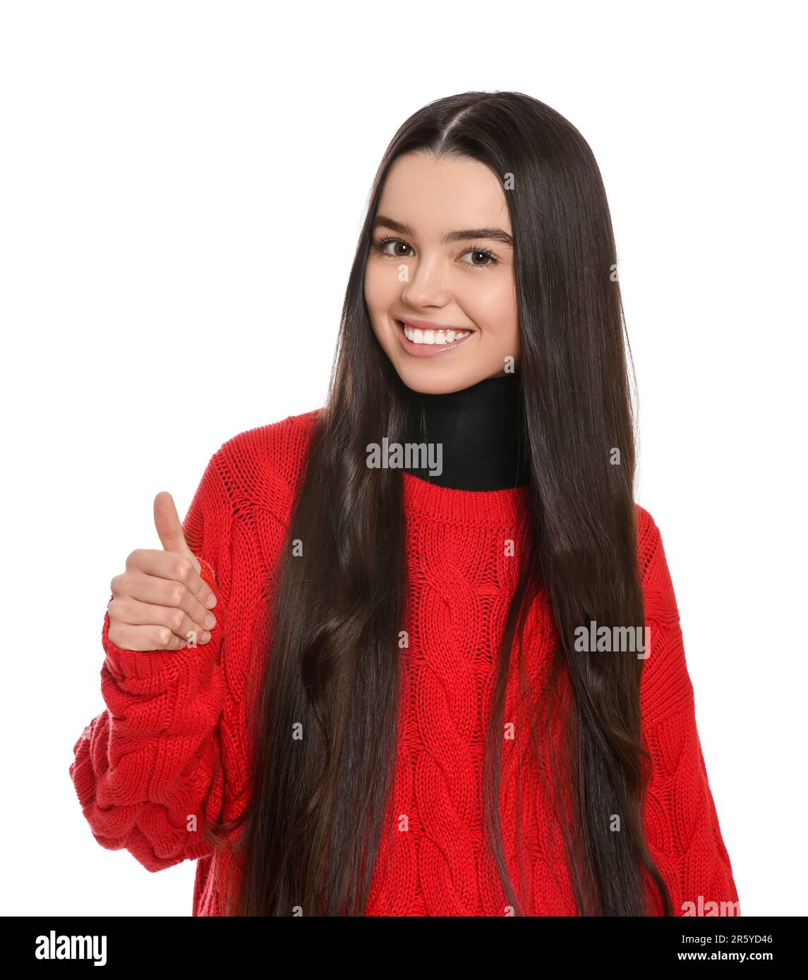 Teenage girl showing thumb up on white background Stock Photo - Alamy
