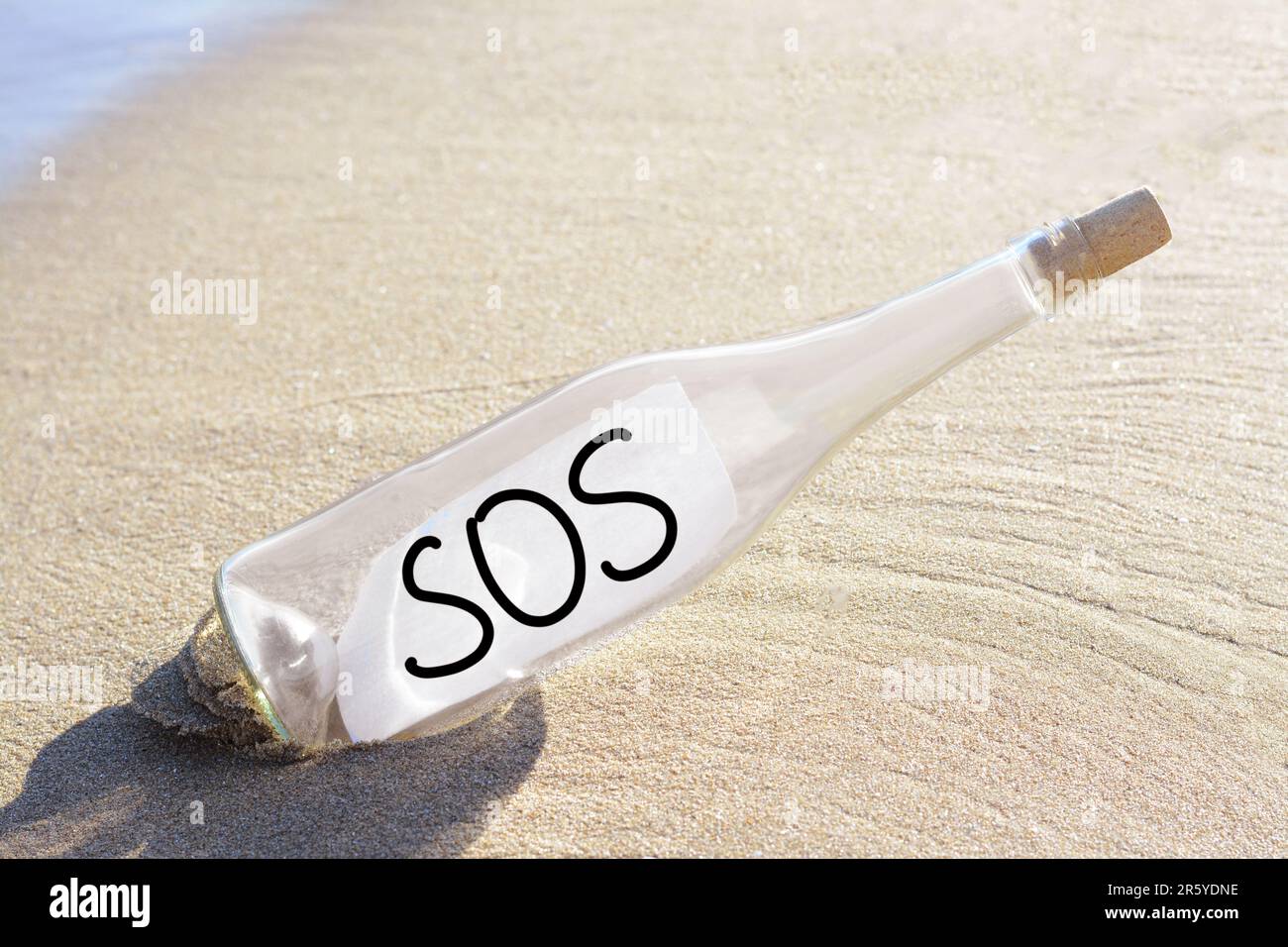 Sos message written on sand hi-res stock photography and images - Alamy