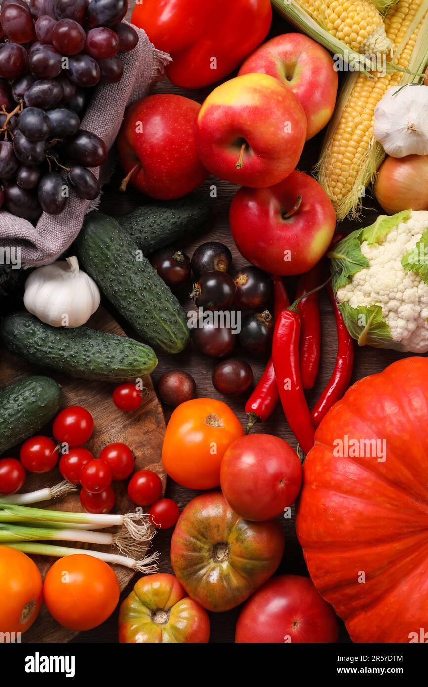 Different fresh ripe vegetables and fruits on wooden table, flat lay ...