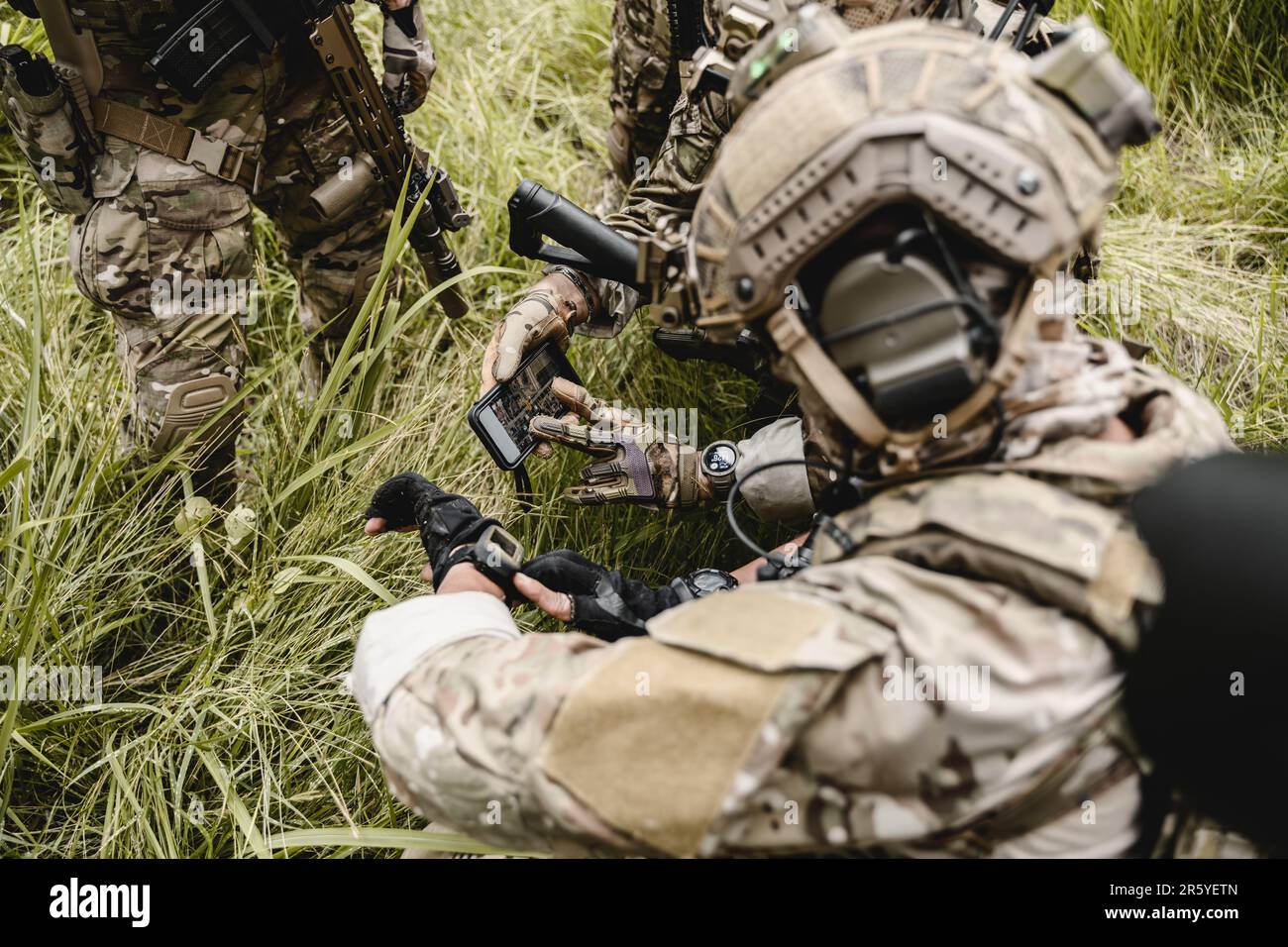 Smart teamwork of soldiers running forward and attacking enemy Stock Photo