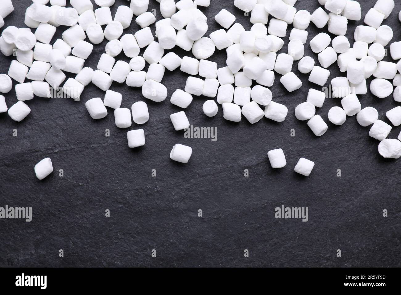 Delicious marshmallows on black background, flat lay Stock Photo