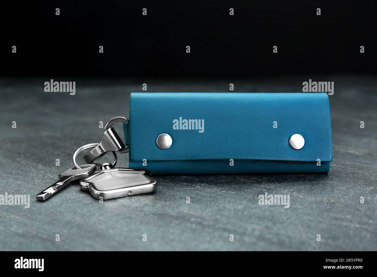 Leather case with key on grey table, closeup Stock Photo