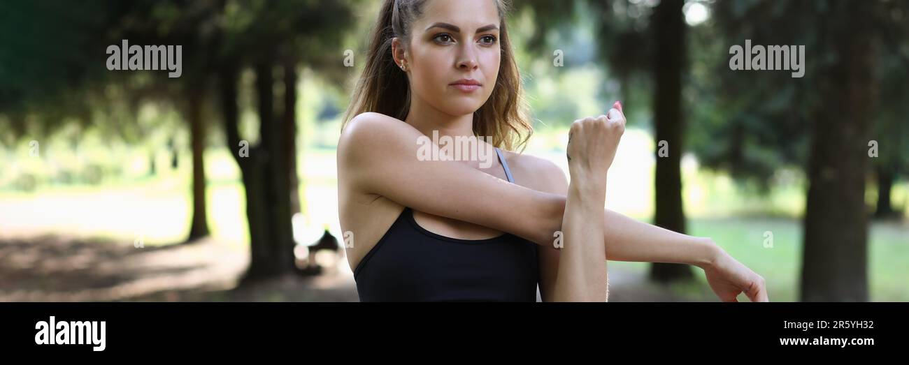 Beautiful fit woman stretching arm hi-res stock photography and images ...