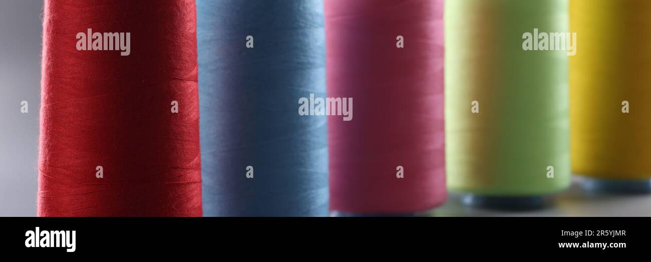 Multicolored thread spools on gray background. Set of colored threads Stock Photo