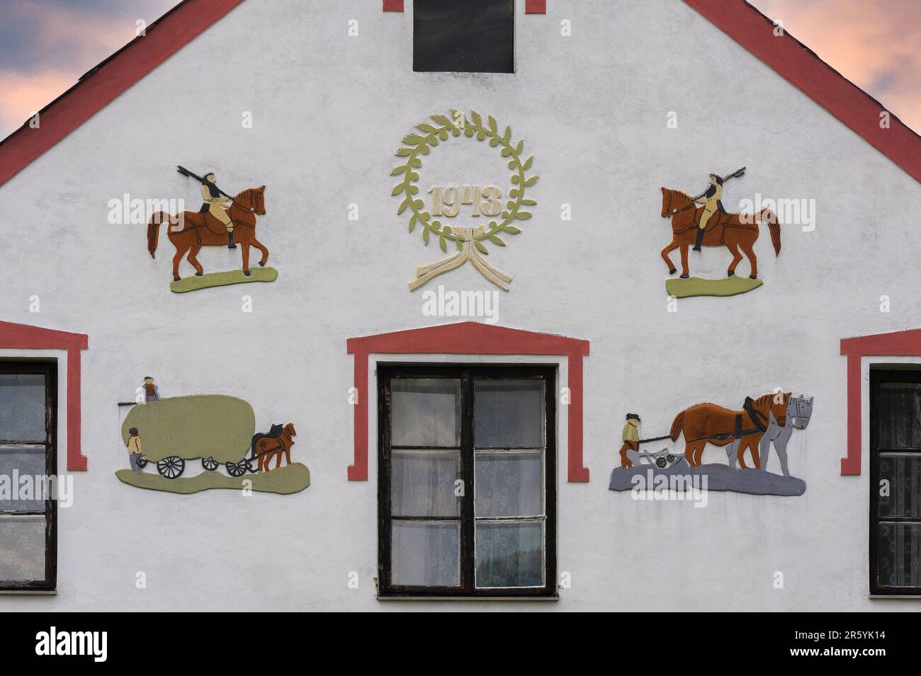 Decorated front of house dated 1943 in Holašovice, South Bohemia, Czech Republic or Czechia, a traditional village included in the UNESCO World Cultural Heritage List. Stock Photo