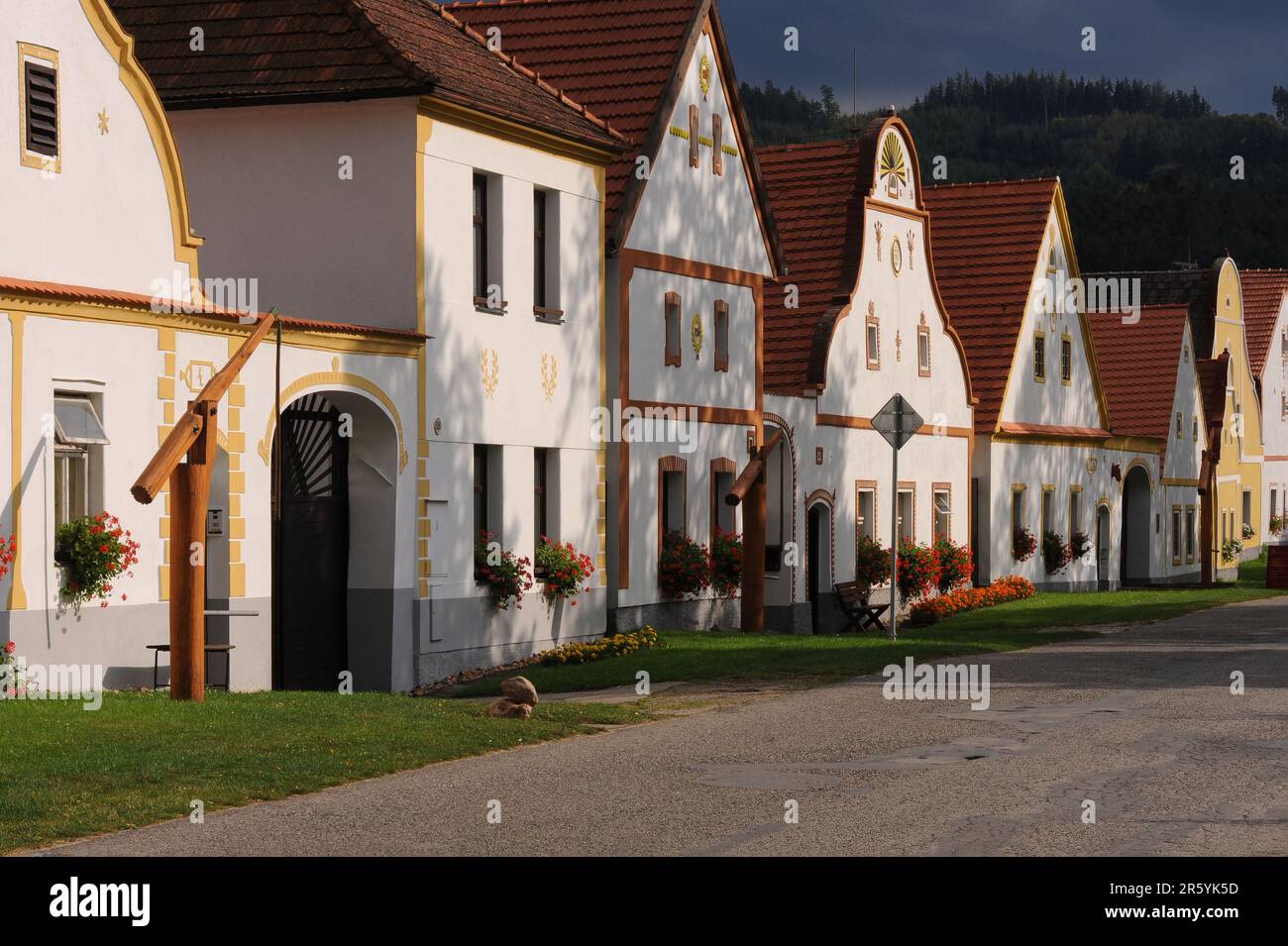 Houses in historic village of Holašovice, South Bohemia, Czechia or Czech Republic. Holašovice is a well-preserved example of a traditional Central European village with many houses rebuilt in the 1800s AD in a style known as South Bohemian Folk Baroque, Rural Baroque or Rustic Baroque.   In 1997 the village was included in the UNESCO World Cultural Heritage List. Stock Photo