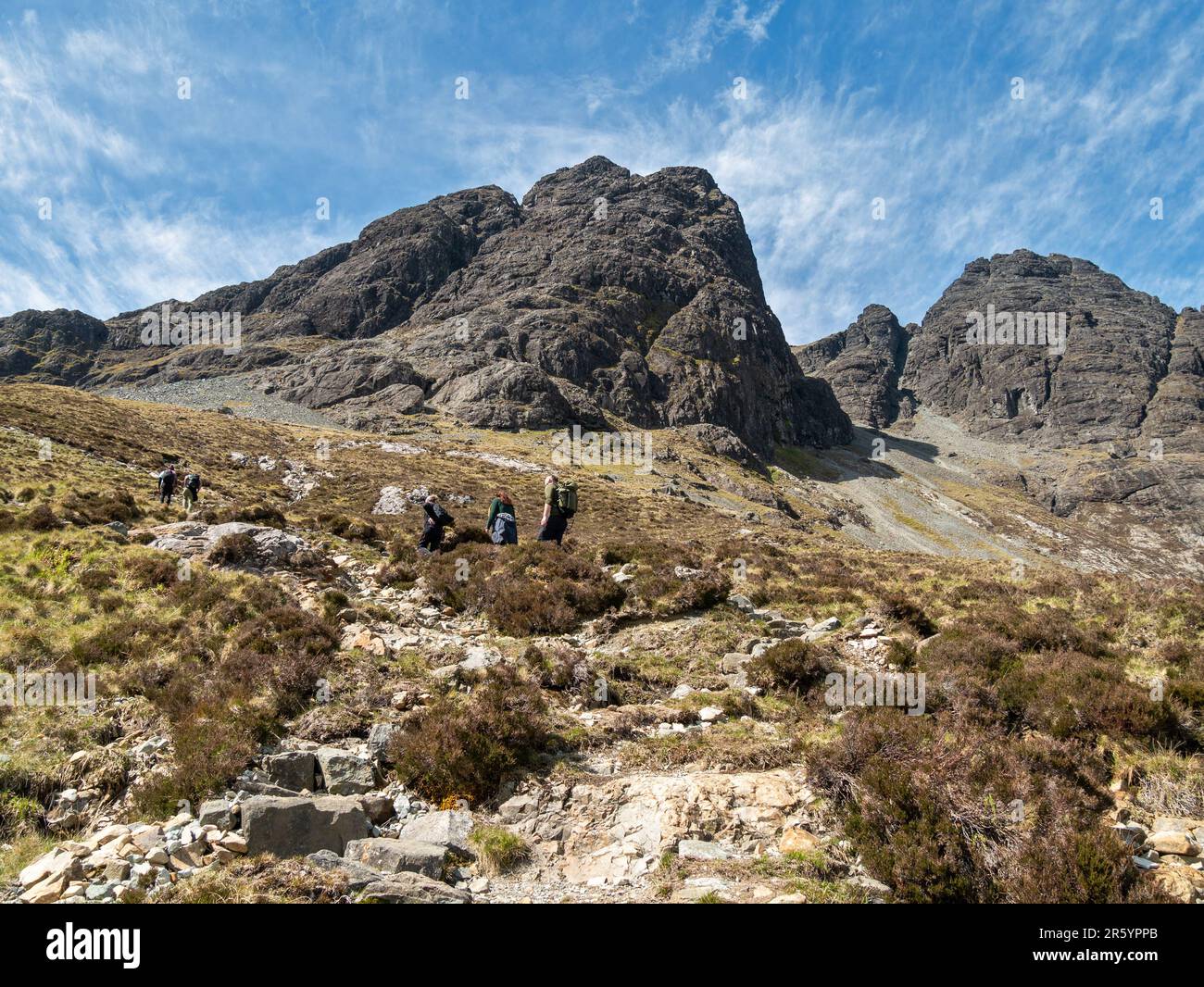 Hill walkers on the path to Blaven (Bla Bheinn and Clach Glas) in the Black Cuillin mountains on the Isle of Skye, Scotland, UK Stock Photo