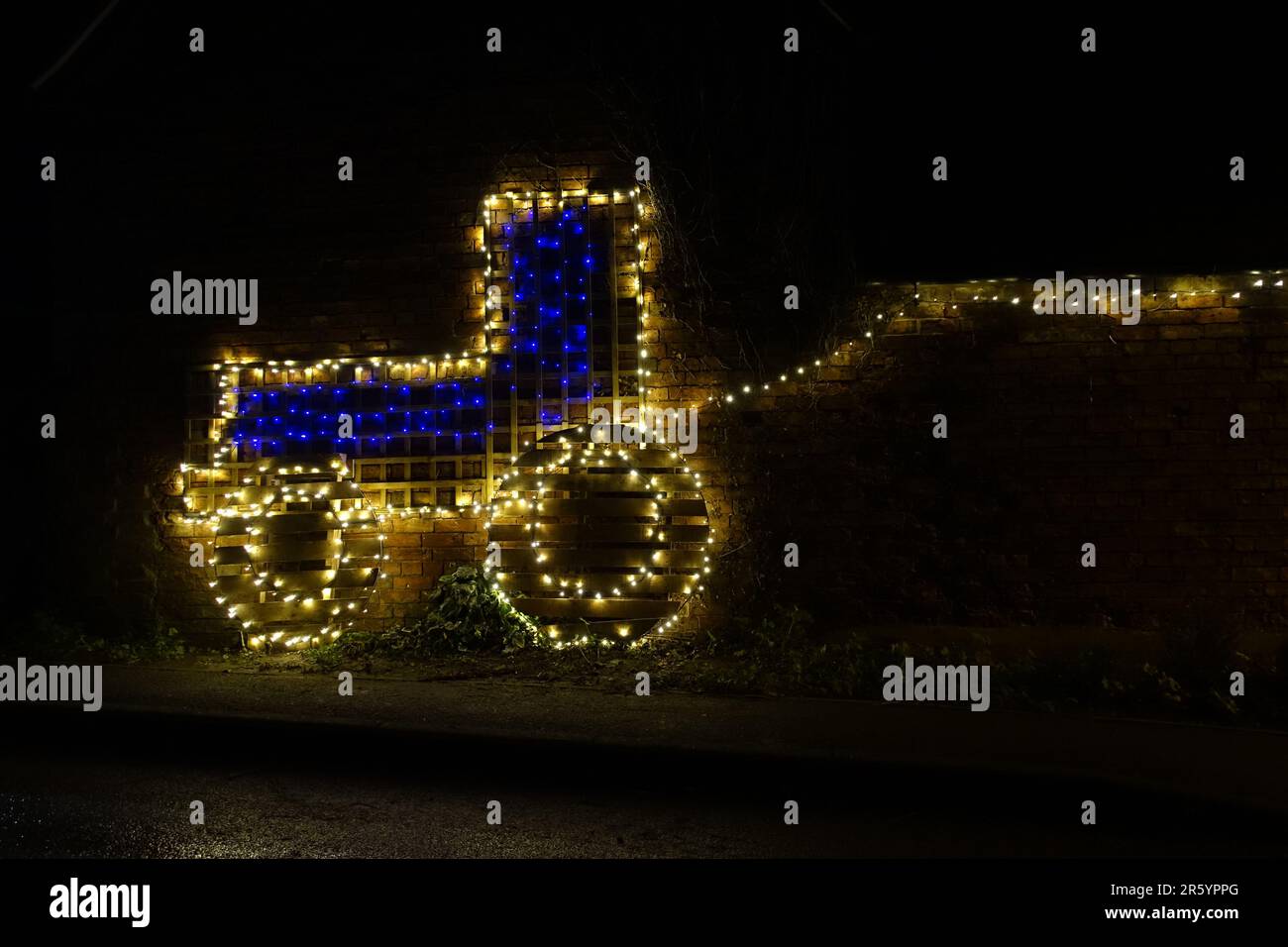 Home made, colourful Christmas light illumination depicting a farm tractor, UK Stock Photo