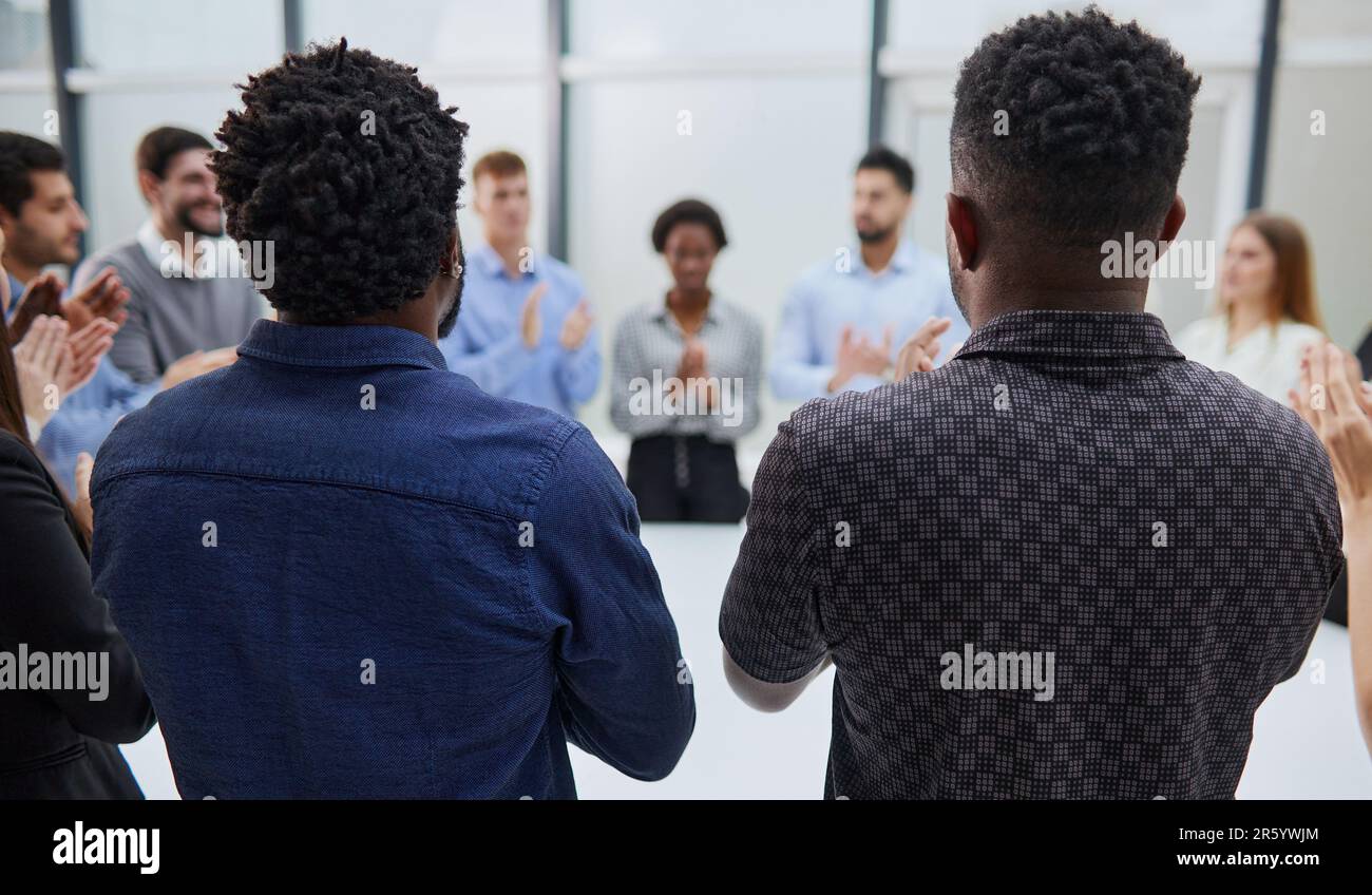 group of employees are sitting in an office, a business conference is going on back view Stock Photo