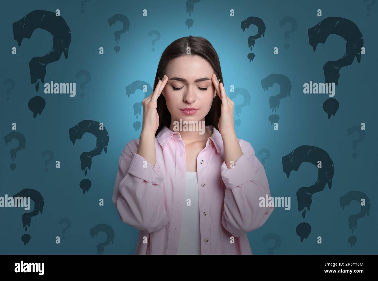 Amnesia concept. Woman trying to remember something. Question marks on color background symbolizing memory loss Stock Photo