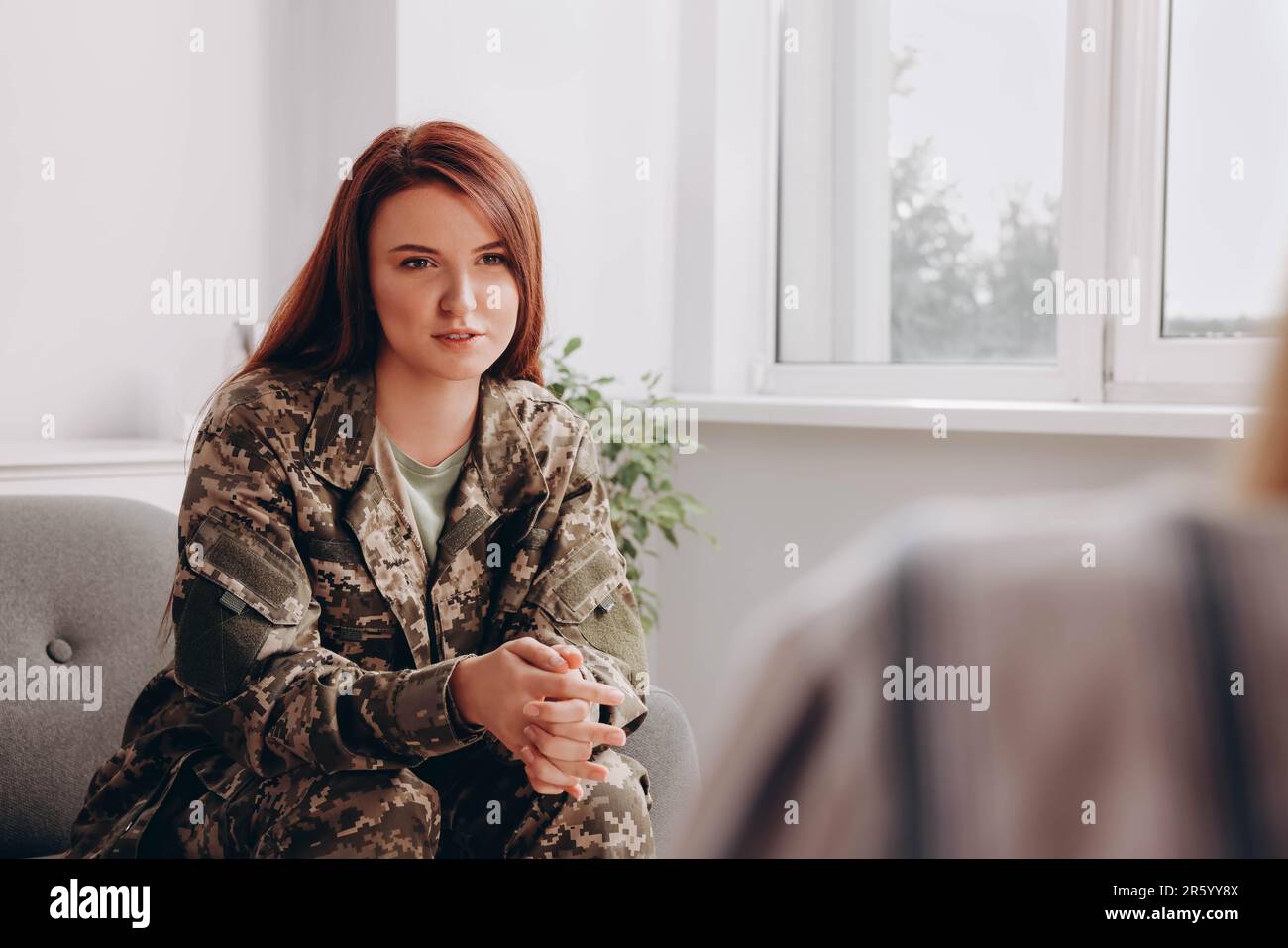Female military officer talking with psychologist in office Stock Photo