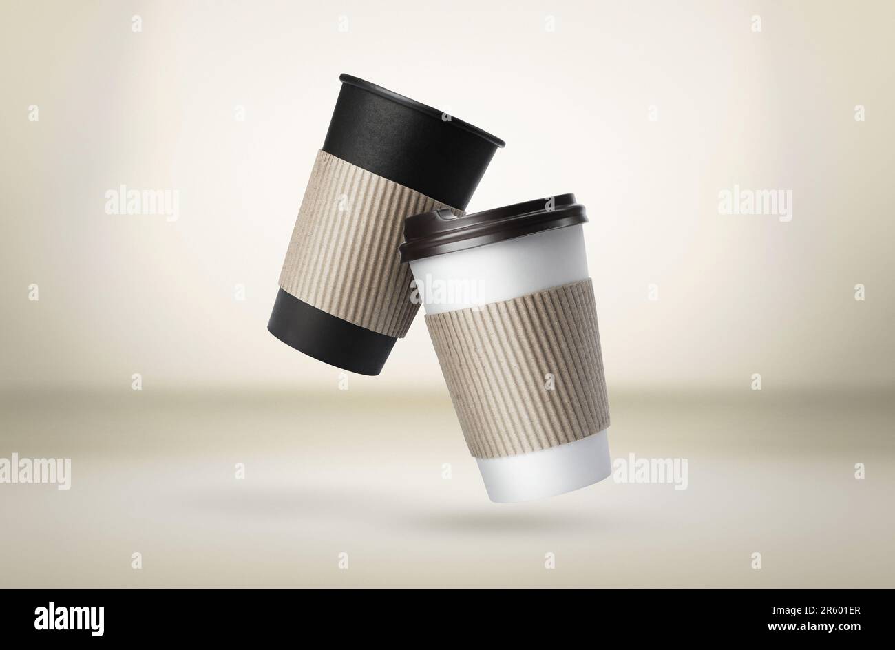 Takeaway paper cups falling on beige background Stock Photo