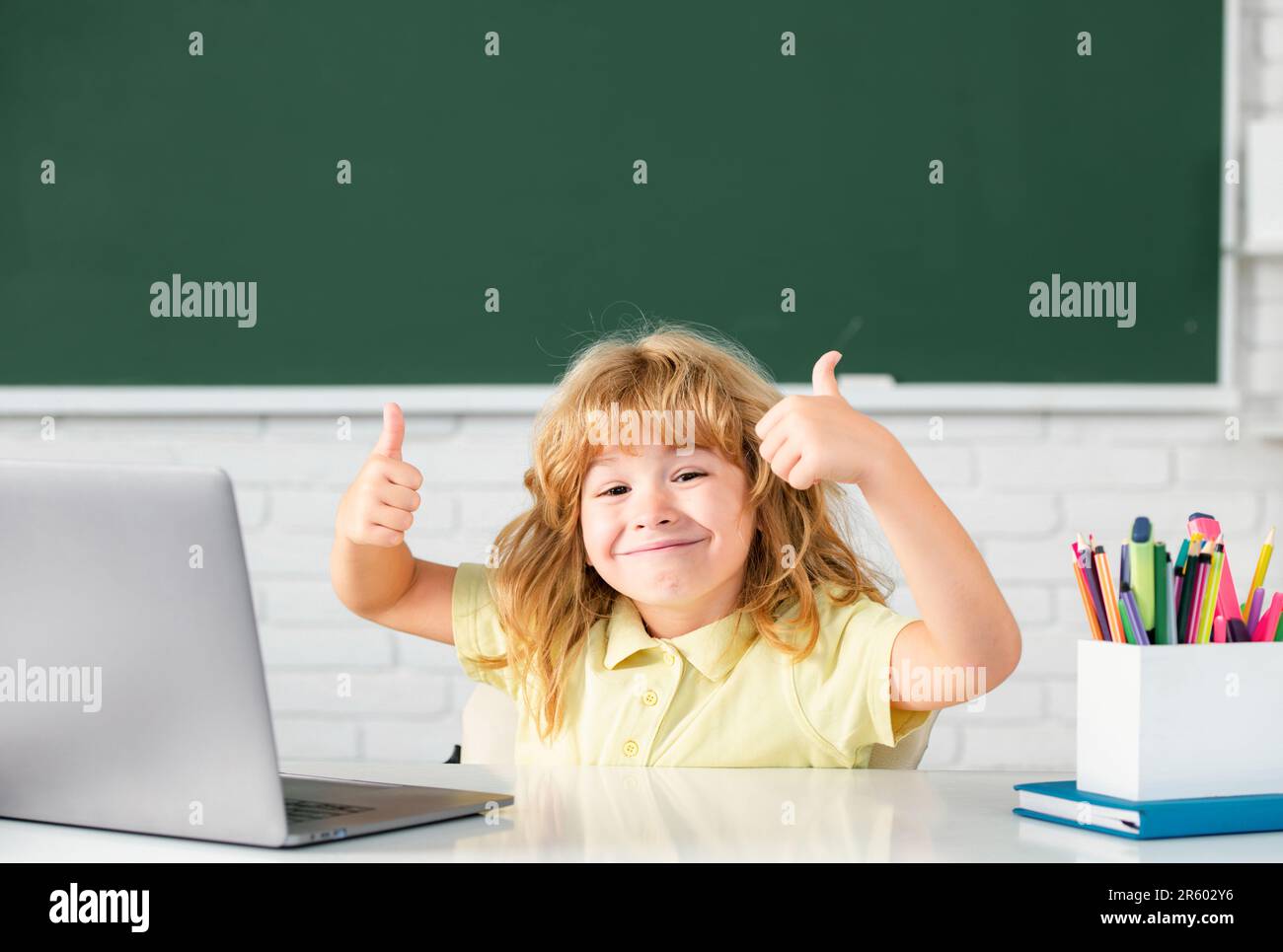 Excited kid boy face with thumbs up learning lesson at school, making ...