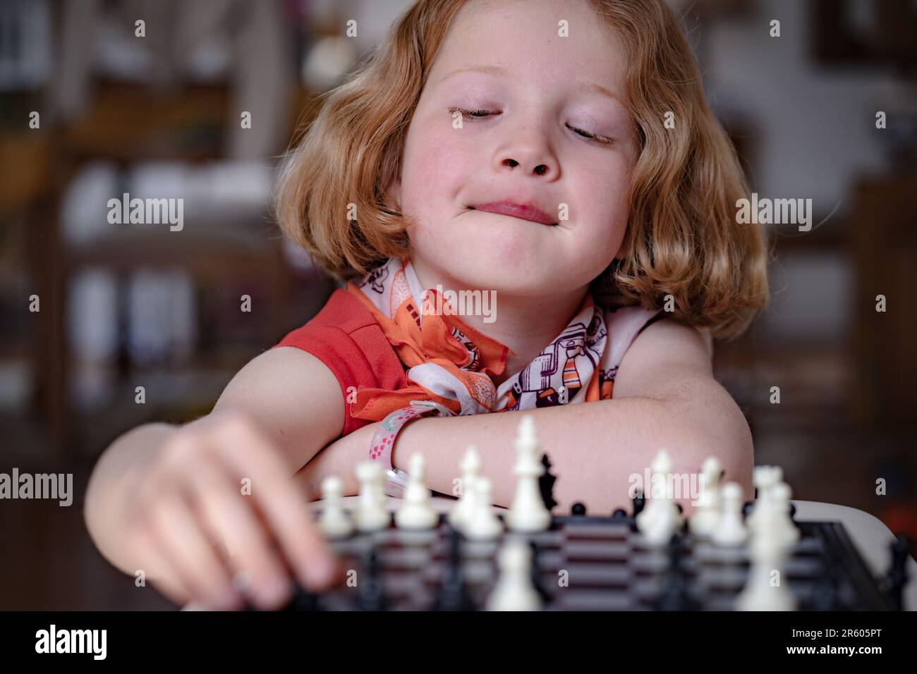 Woman playing chess thinking of next move Stock Photo - Alamy