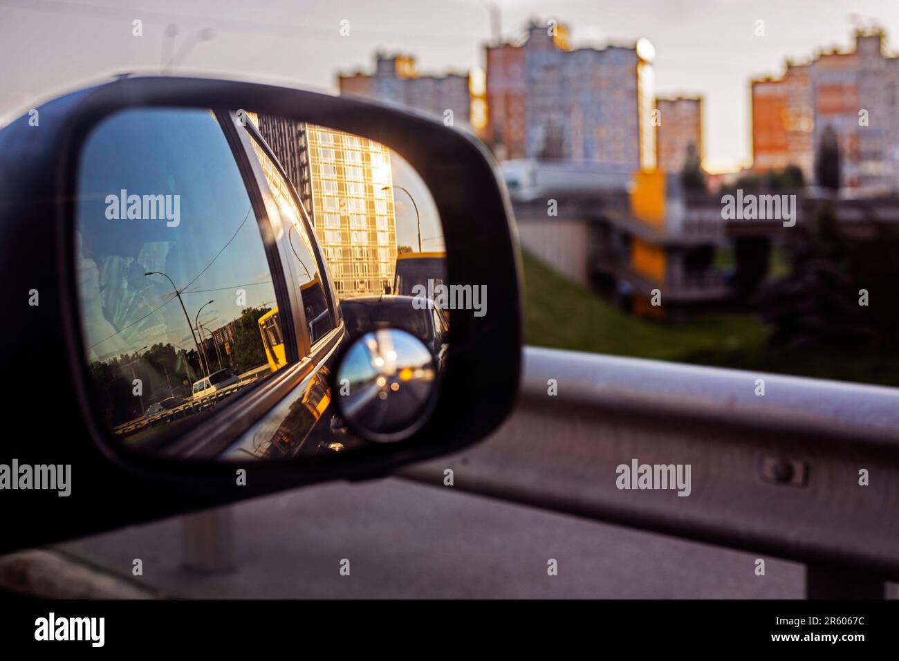 view of the sky in the right side car mirror in the evening. Traffic jam in the city Stock Photo