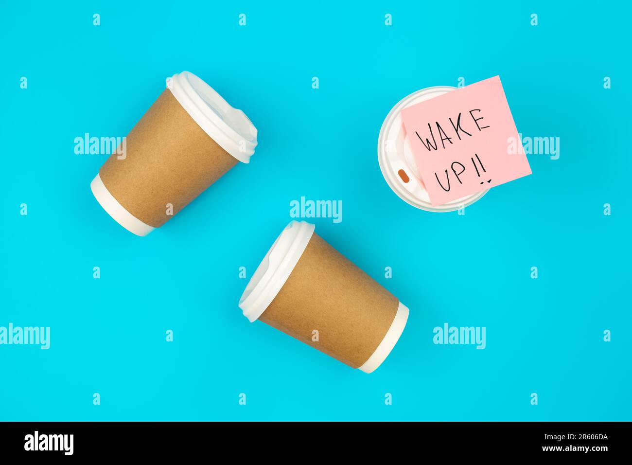 Paper disposable cups and paper reminder with text Wake up Stock Photo