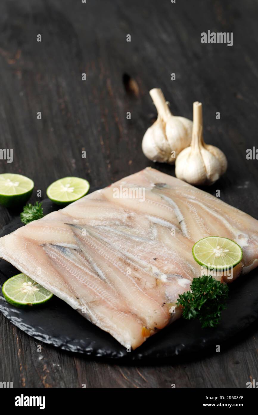 Frozen Catfish Fillet on Black Slate Plate, Fillet Ikan Lele Stock