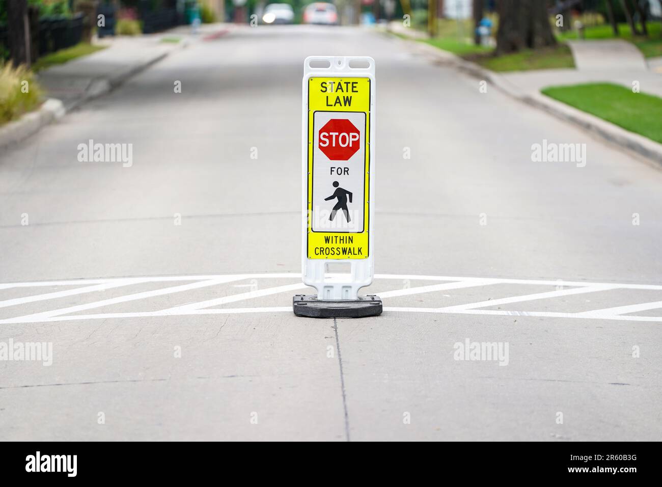 State Law Pedestrian Crosswalk Sign on a busy street in a neighborhood Stock Photo