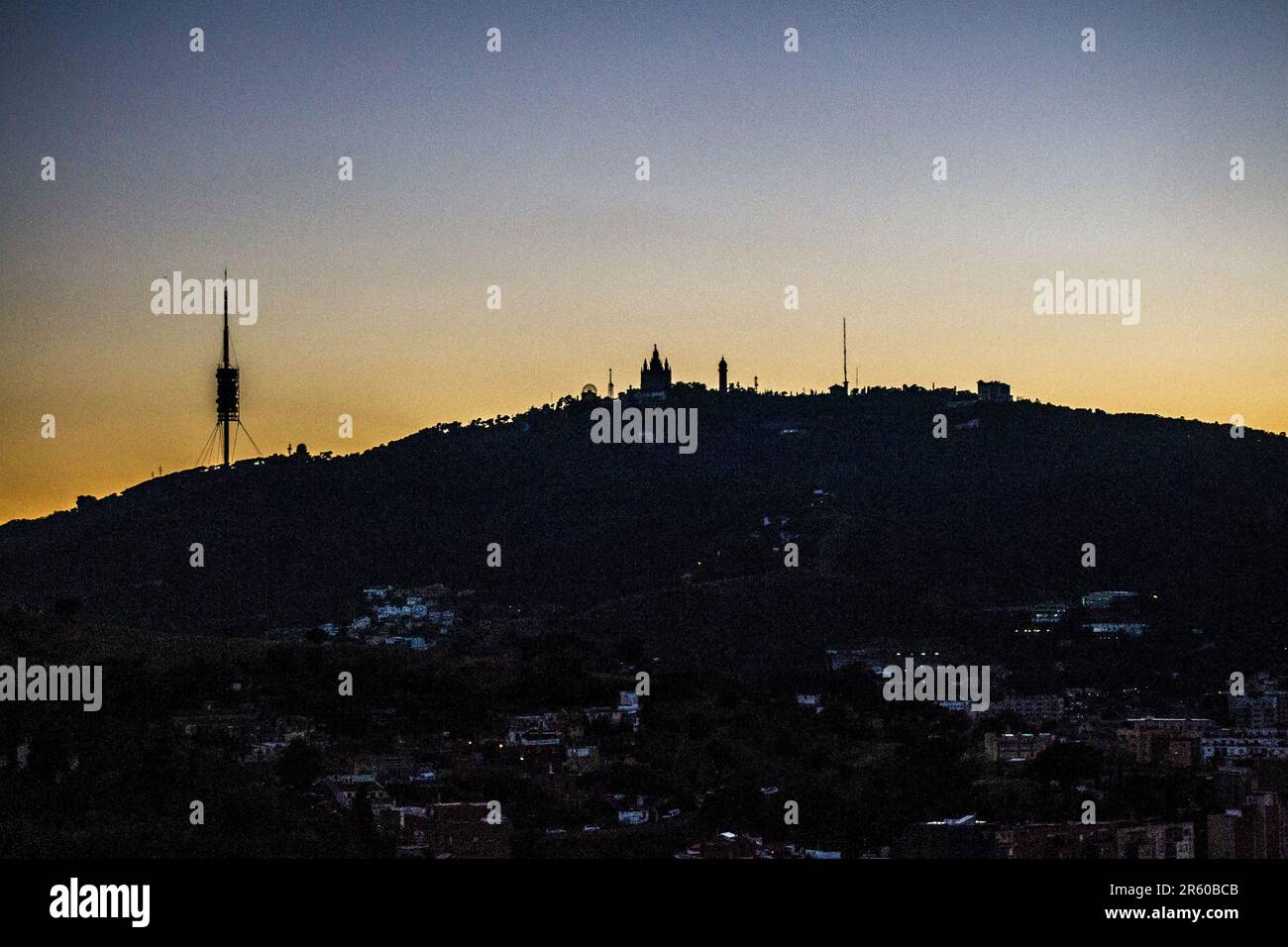 Night view of the mountain of Tibidabo, Barcelona taken from the hill called Turo de la Rovira. A sunset in early summer. Stock Photo