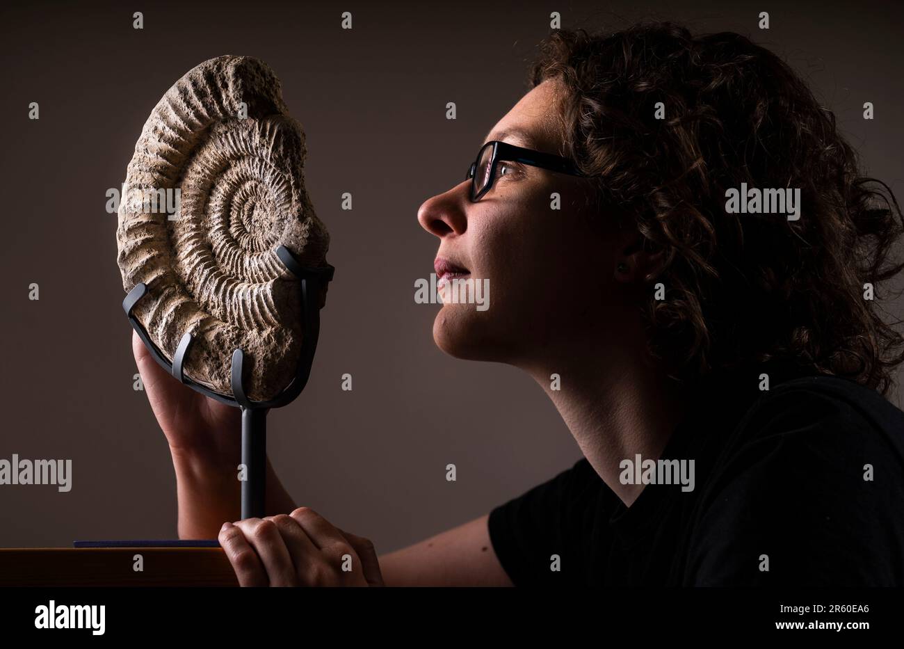 Dr Rebecca Bennion with a 160 million year old Upper Jurassic ammonite from the Whitby Museum collection, ahead of the Yorkshire Fossil Festival in Whitby, North Yorkshire. Picture date: Tuesday June 6, 2023. The Yorkshire Fossil Festival takes place in Whitby on the 10 and 11 June and features a wide range of fossil experts and geologists, as well as circus acts and street theatre from across the world. Stock Photo