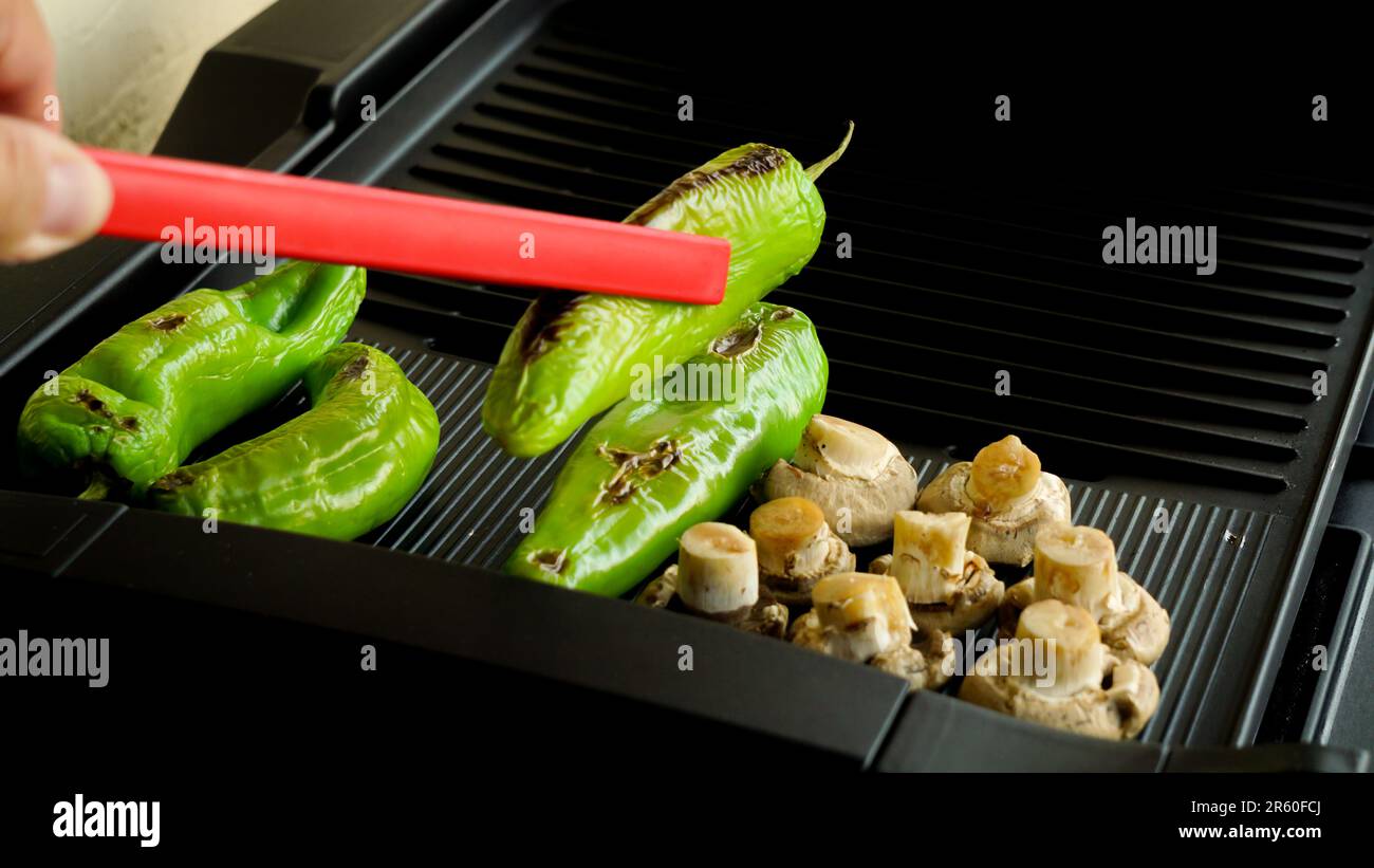 Smokeless barbecue cooking at home close up view Stock Photo
