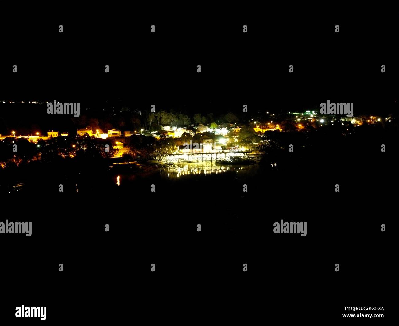 Aerial view of a bustling city at night, illuminated by twinkling ...