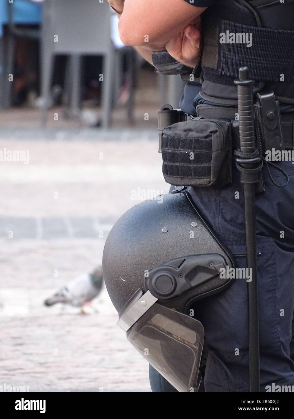 A law enforcement officer wearing a uniform and protective gear poses