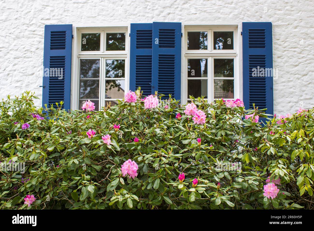 Old German house with wooden windows with wooden shutters and