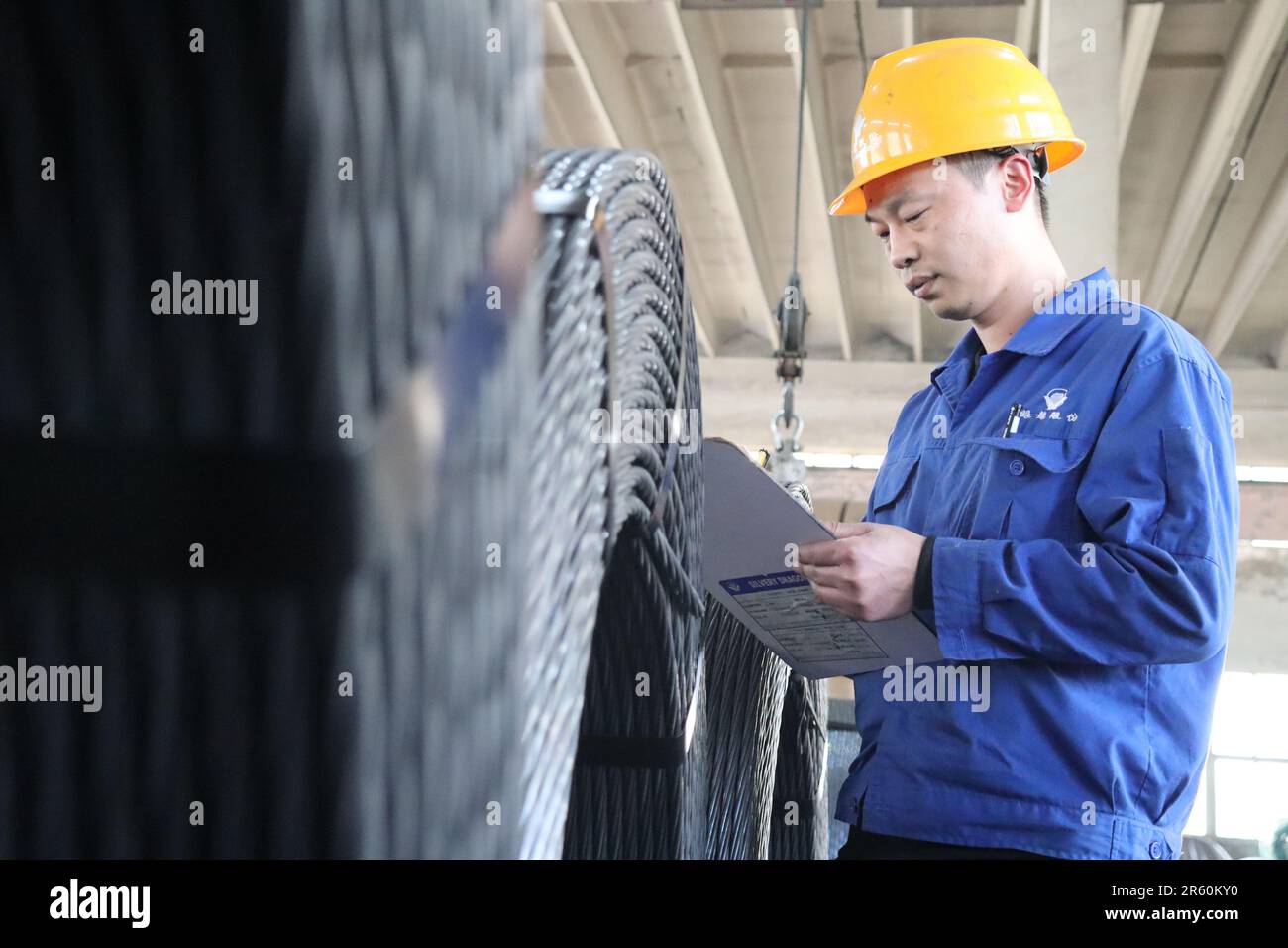 Tianjin, Ltd. in Beichen District of north China's Tianjin. 15th Mar, 2023. An employee works at a storehouse of the Silver Dragon Prestressed Materials Co., Ltd. in Beichen District of north China's Tianjin, March 15, 2023. TO GO WITH 'Economic Watch: Heavy industrial enterprises eye green, innovative shift' Credit: Guo Fangda/Xinhua/Alamy Live News Stock Photo