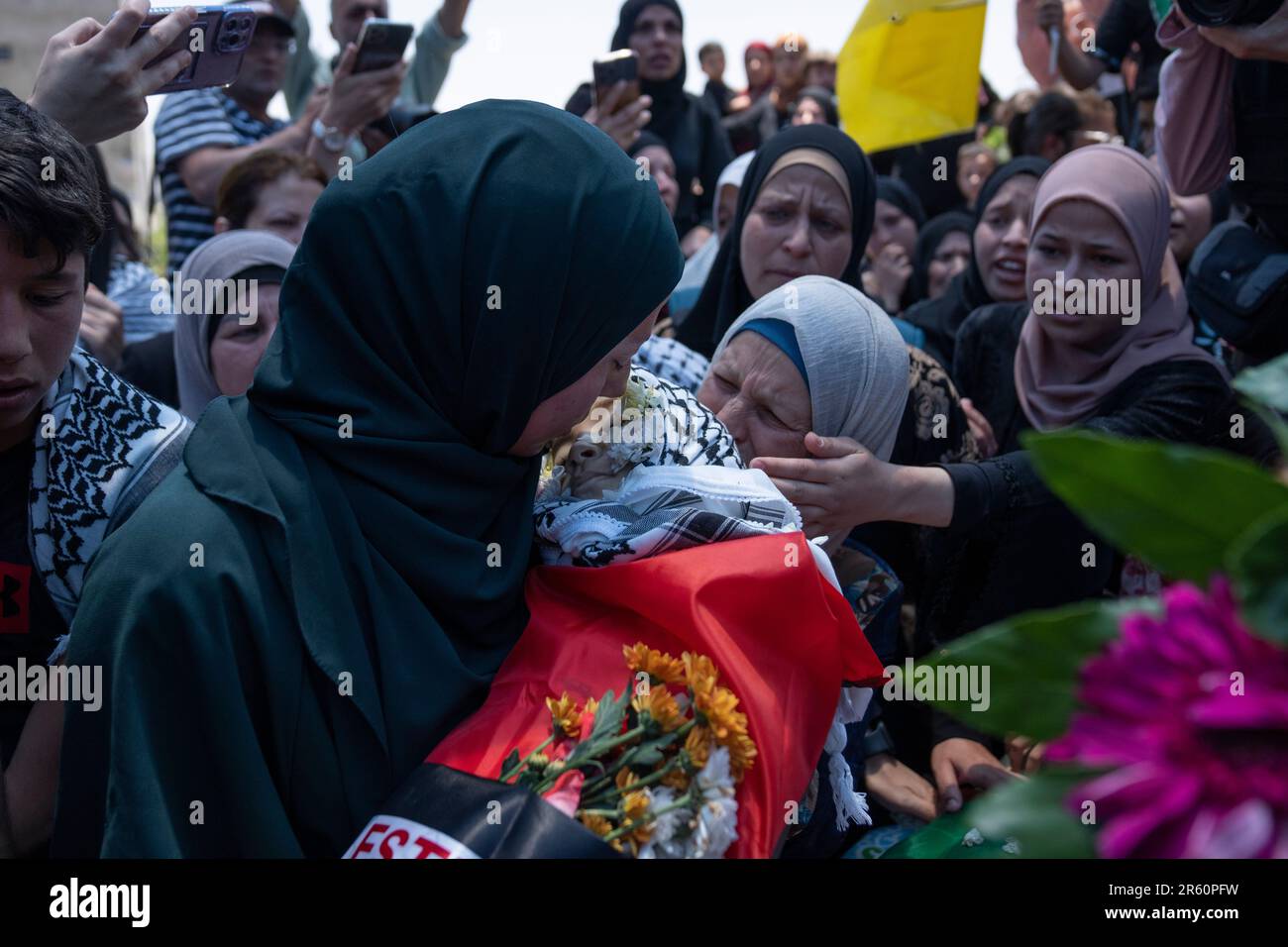 Palestinian Marwa al-Tamimi, 32 carries the body of her 2 year old