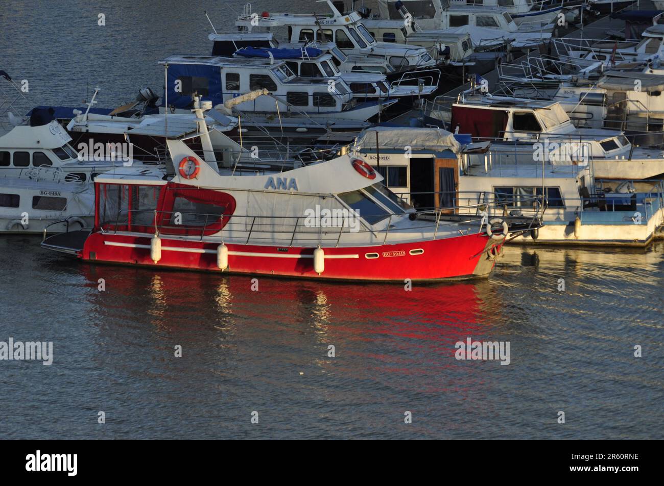 White n red boat in marina with reflection Stock Photo - Alamy