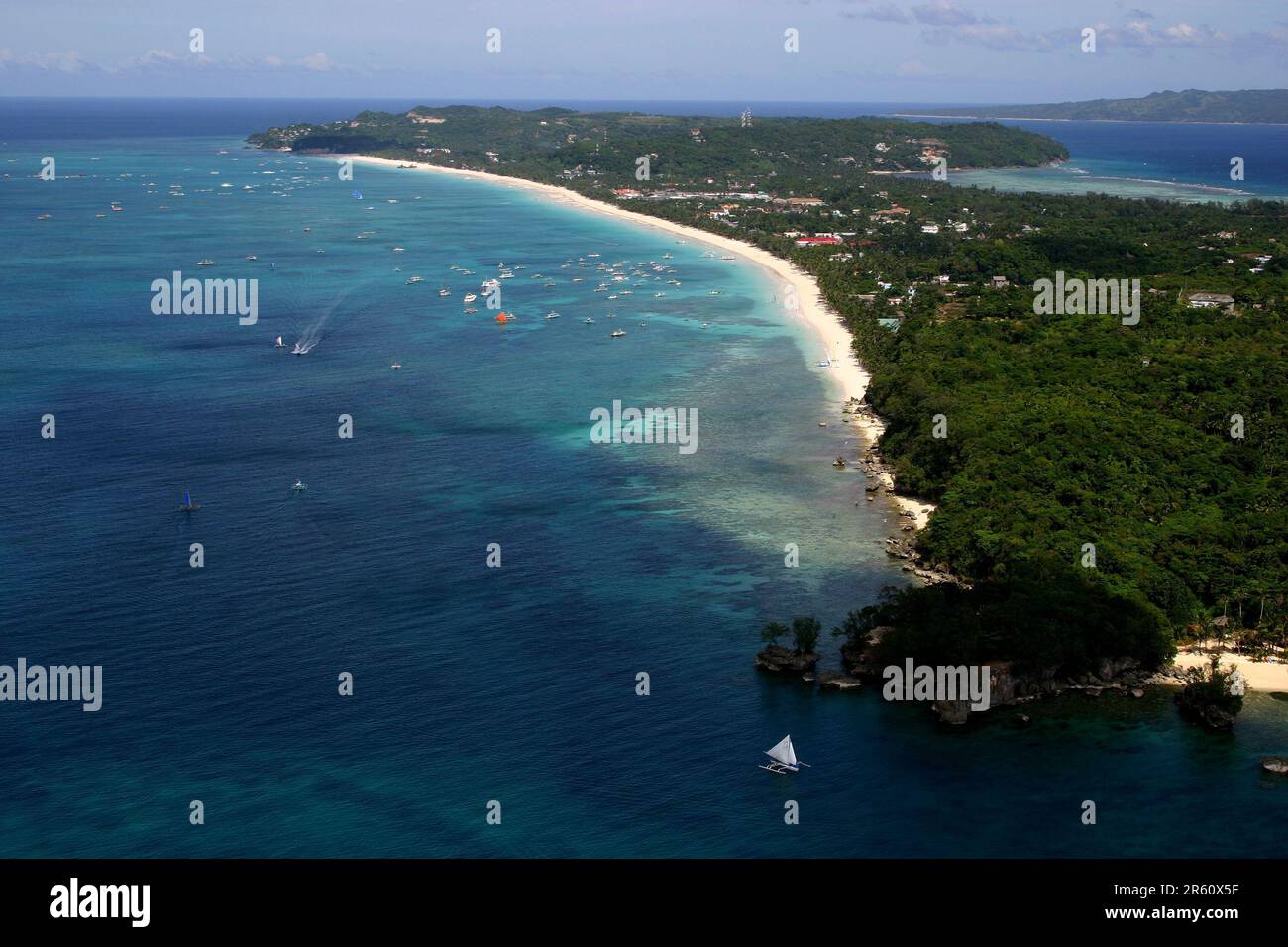 A tranquil body of water surrounded by lush vegetation with several ...