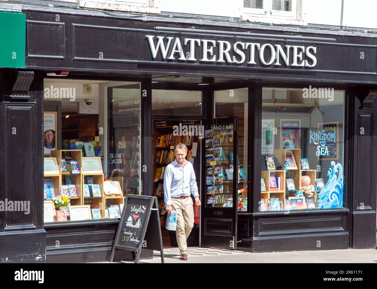 Customer leaving Waterstones book shop in the South Wales market town