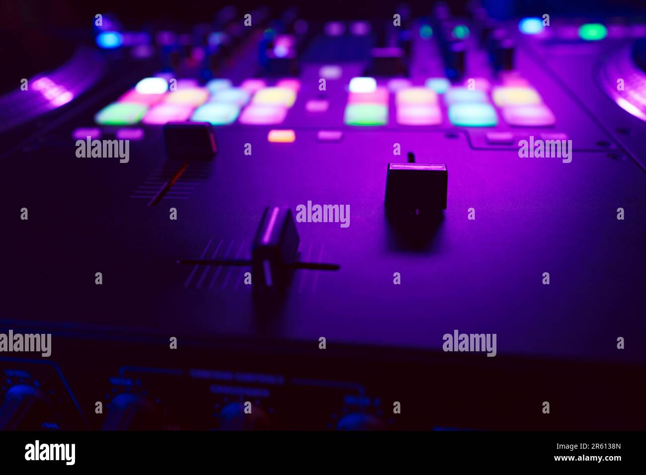 Close up of DJ mixing console in party light Stock Photo - Alamy