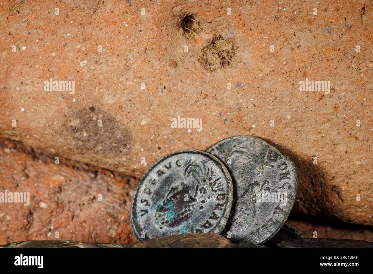 A closeup shot of ancient roman coins on bricks. Stock Photo