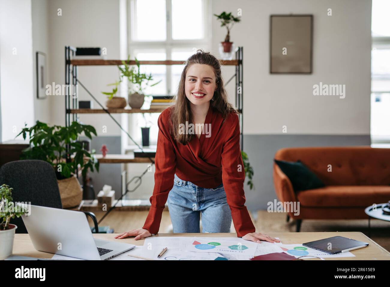 Portrait of young happy woman in office. Stock Photo