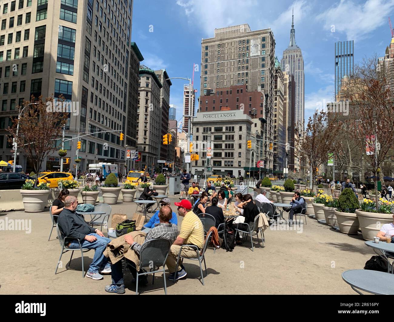 A group of friends enjoy an alfresco lunch at a cafe set up in Madison Square park in New York City Stock Photo