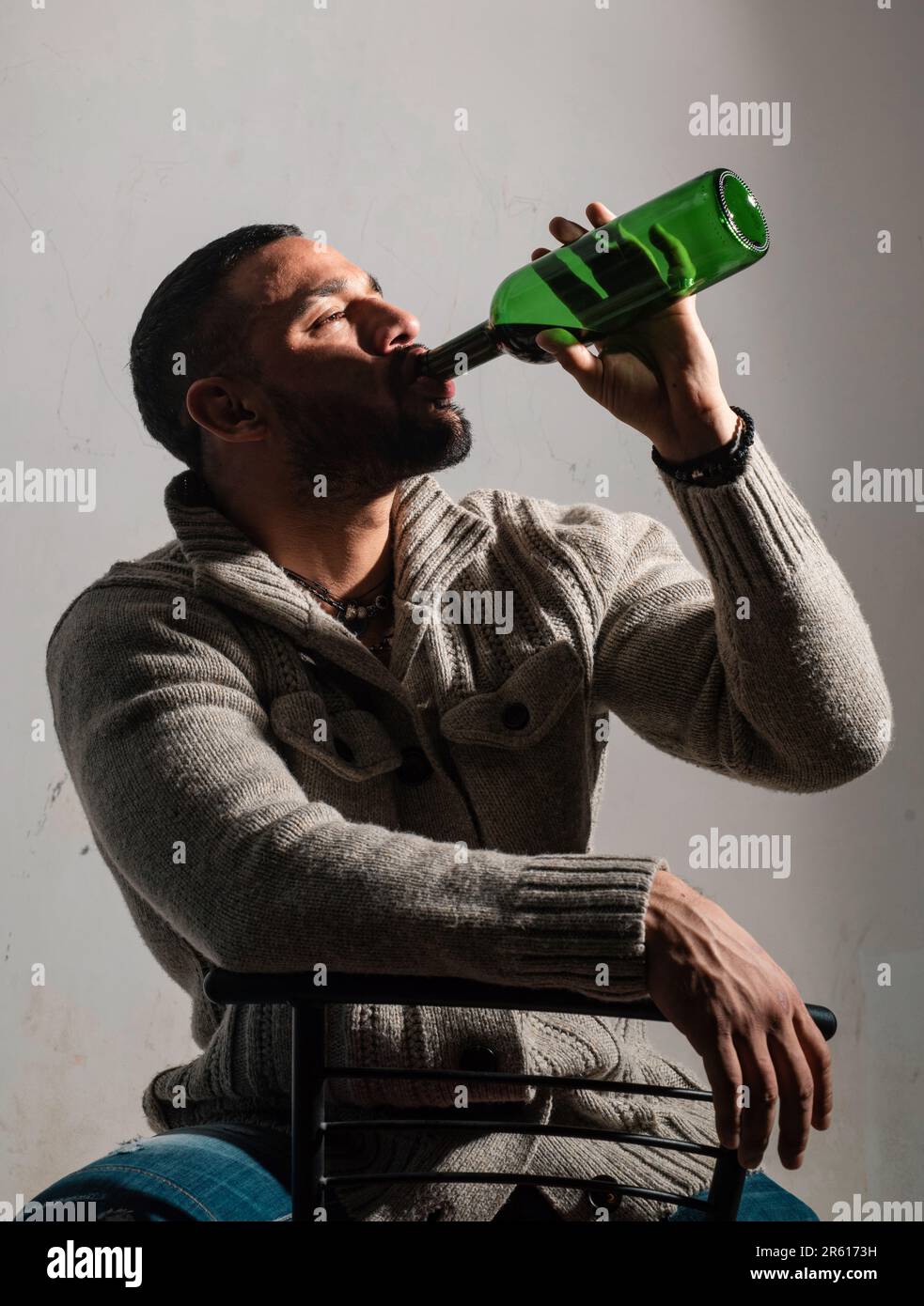 Drunk man drinking wine. Depressed guy with bottle alcohol. Abuse in